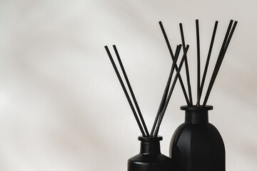 Minimalist Aromatic Reed Diffusers on a Wooden Surface Against a Soft Background - obrazy, fototapety, plakaty