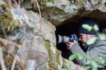 birdwatcher with a camera in a national park hideout