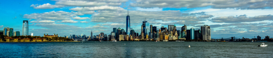 Lower Manhattan of NYC New York City taken from liberty island. This also known as Downtown Manhattan or Downtown New York the largest business district in state of New York and USA. - obrazy, fototapety, plakaty