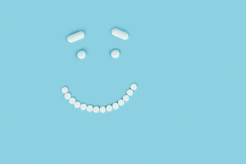 smiling smiley face made of pills on a blue background