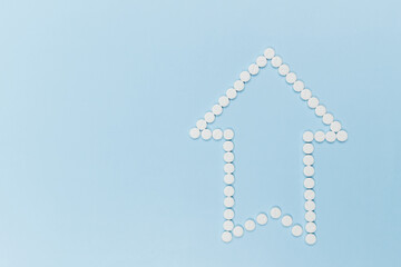 an arrow pointing to the top, made of identical white tablets on a blue background