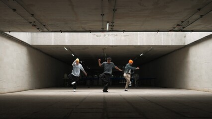 Panorama shot of hipster group dance together while perform b-boy dance. Street dancer team moving to hip hop music while doing freeze pose. Break dance, street dance. Outdoor sport 2024. Sprightly. - obrazy, fototapety, plakaty
