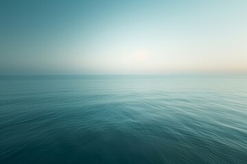 Obraz premium Tranquil sea view at dawn, focusing on the play of light on the water's surface, with a minimalist approach to convey a sense of calm and serenity