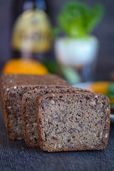 Loaf of bread and sliced bread on table, part of baked goods