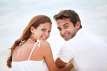 Fototapeta premium Happy couple, portrait and love in nature for romantic and travel on honeymoon by sky background. Man, woman and smile on face for bonding together with care, peace or trip for commitment in marriage