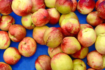 A beautiful fragrant ripe nectarine, the view from the top. Nectarines in the market. A group of colorful nectarine fruits on a market.