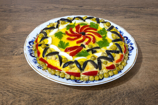 Traditional Romanian boeuf (beef) salad decorated for Christmas or Easter on a wooden table