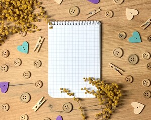 Notepad on a wood background with plant and wood beads border - 768519769