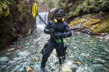 Portrait of scuba diver holding his metal detection equipment