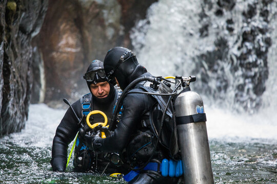 Team of divers assess instruments and equipment before a dive