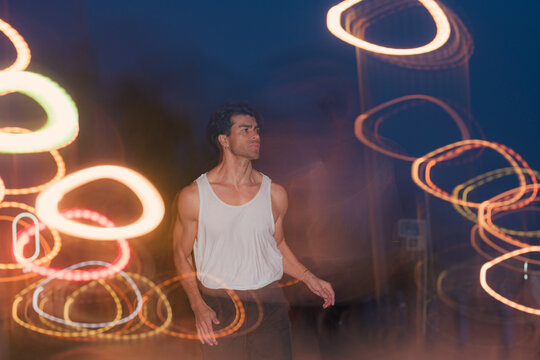 Athletic man jogging in tank top on city street