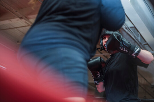 Young Girl sparring with partner in boxing ring
