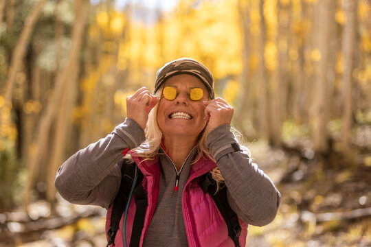 A woman with yellow leaves adorning her eyes
