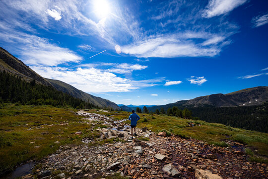 Trail runner on the trail up to Arapahoe Pass in Colorado.