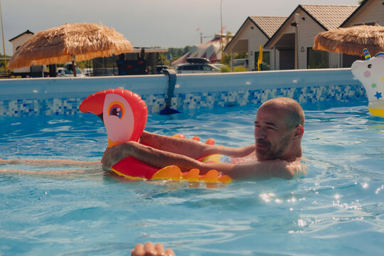 A man happy swimming in a pool