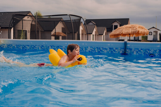 Boy happy swimming in a pool