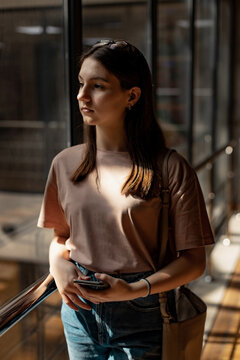 Teenage girl with long hair near the window