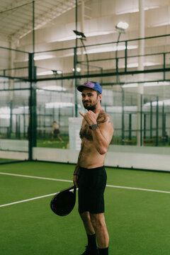 Man play padel tennis on an indoor court, Bali.