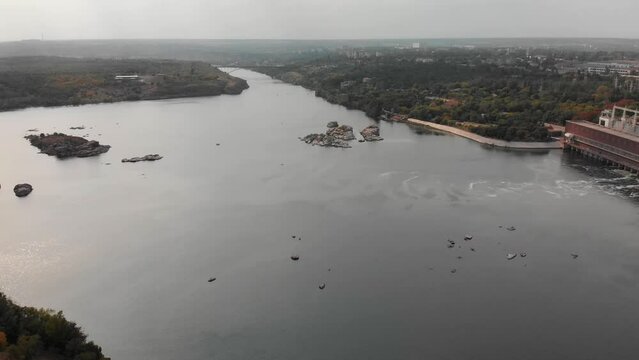 Beautiful view from above of the Khortytsia island in Zaporozhye. Drone view of the Dnieper River and the bridge. Multi-storey buildings, forest. Embankment in Zaporozhye.