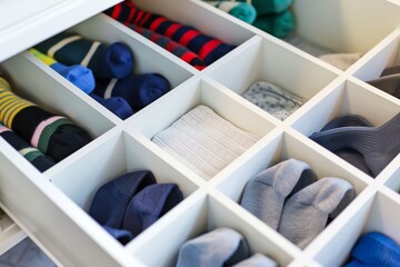 sock drawer with one empty section, all other compartments full