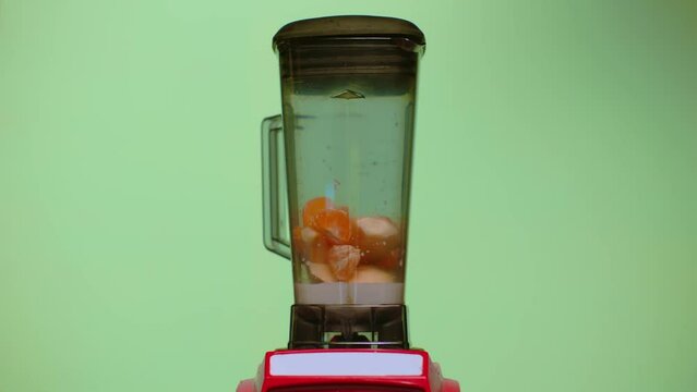 Process of milk and fruits blending. Coctail maiking. Fresh milkshake with pears and oranges.