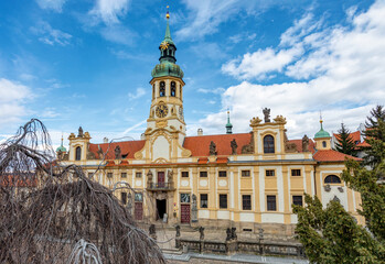Loreta Monastery, pilgrimage destination in Hradcany, district of Prague. Cloister, the church of the Lords Birth, the Santa Casa and clock tower with famous chime. Central Bohemia, Czech Republic - 768533724