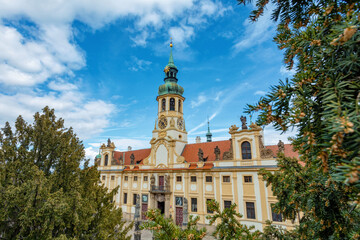 Loreta Monastery, pilgrimage destination in Hradcany, district of Prague. Cloister, the church of the Lords Birth, the Santa Casa and clock tower with famous chime. Central Bohemia, Czech Republic - 768533727