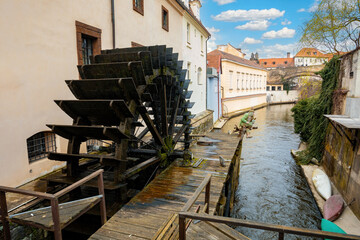 Kampa Island, known as Venice of Prague, in the Mala Strana with small river Devil, Certovka. In front mill-wheel. Central Bohemia, Czech Republic - 768533757