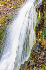 Falling water in a waterfall on a cliff