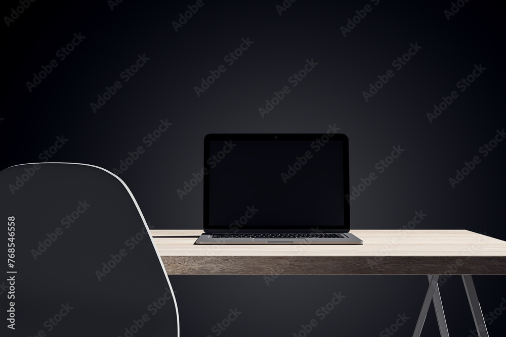 Poster close up of dark designer office desk with mock up laptop on wooden table. 3d rendering.