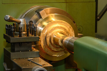 The lathe machine finish cut the brass material parts by lathe tools.