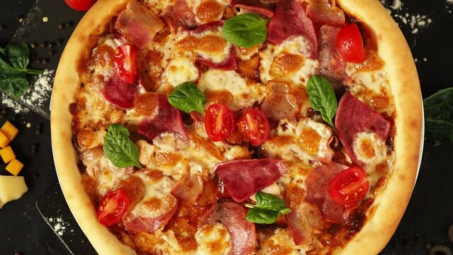 Pizza with thick crust. Meat pizza on a black table with scattered ingredients. Storytelling for a vertical screen. real italian traditional pizza