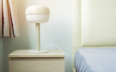 Bedroom modern design with furnishing. Wooden bedside with modern lamp.