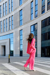 Stylish woman in a pink suit