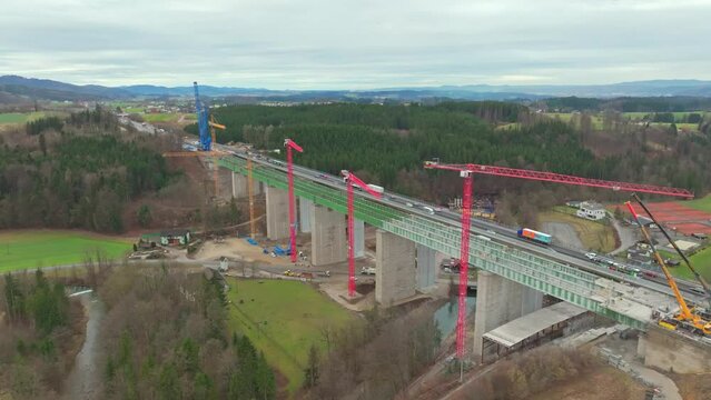 Industrial Cranes At The New Highway Bridge Adjacent To Aurach Bridge In Austria. - aerial shot