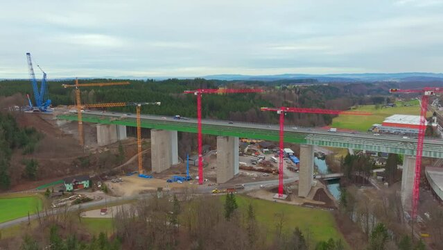 Cars Driving Through The Old Aurach Bridge Next To The New Bridge Under Construction In Regau, Austria. - aerial shot