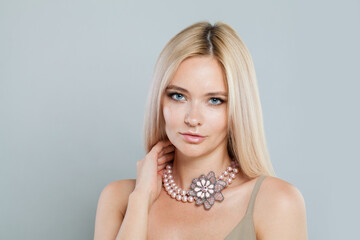 Bright fashion female model with long blonde hairstyle and shiny fresh skin on white background, studio portrait - 768560918