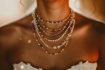 closeup of layered necklaces on a glowing bride