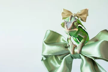Tuinposter chameleon on a green metallic headband with a bow © studioworkstock
