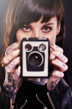 Person, hands and camera with tattoo for vintage, polish and creative for ink and design for picture and symbol. Art, bold and portrait for cool and capture for photographer, trend, edgy and gold