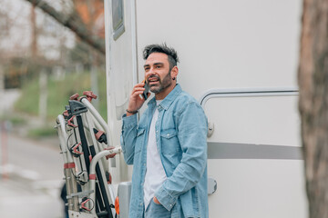 attractive traveler man with caravan and mobile phone - obrazy, fototapety, plakaty