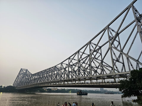 Howrah bridge - The historic cantilever bridge on the river Hooghly with evening sky. Howrah bridge is considered as the busiest bridge in India.