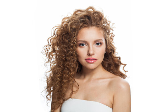 Nice good-looking redhead woman with clean skin, curly hairstyle and natural make-up. Female model on white background