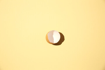Organic cracked egg on a yellow background,
hatched chick, cracked eggshell, easter concept
