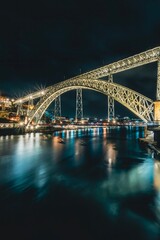 Night skyline from the Dom Luis I bridge in Porto, Portugal, on the banks of the Douro river, cityscape at night.