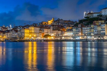 Obraz premium Night skyline of Porto, Portugal, on the banks of the Douro River, cityscape at night.
