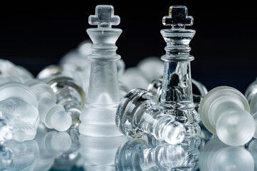 glass chess board game in black background ,selective focus on King, leadership concept