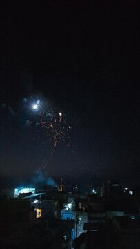Slow motion of firecrackers bursting against a dark background during Diwali celebrations in Khambhat, India