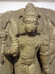 A finely detailed stone sculpture of a Jain Tirthankara Parshwanath statue, with a serene...
