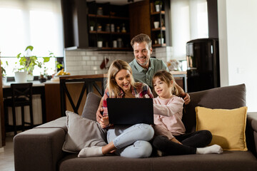 Family Bonding Time With Laptop in Cozy Home Setting - 768598162